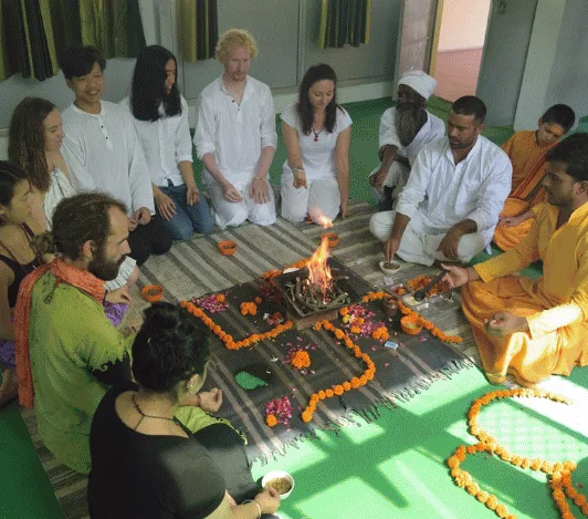 Havan fire ceremony with marigolds at Avatar Yoga School
