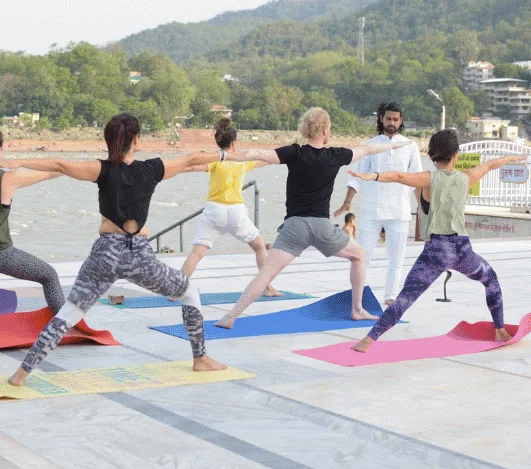 Warrior pose beside the Ganga in Rishikesh