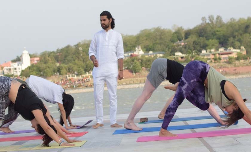 Teacher guiding a student during Kundalini yoga teacher training