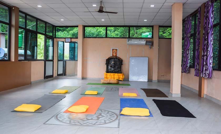 Yin yoga hall with bolsters and blocks at Avatar Yoga School